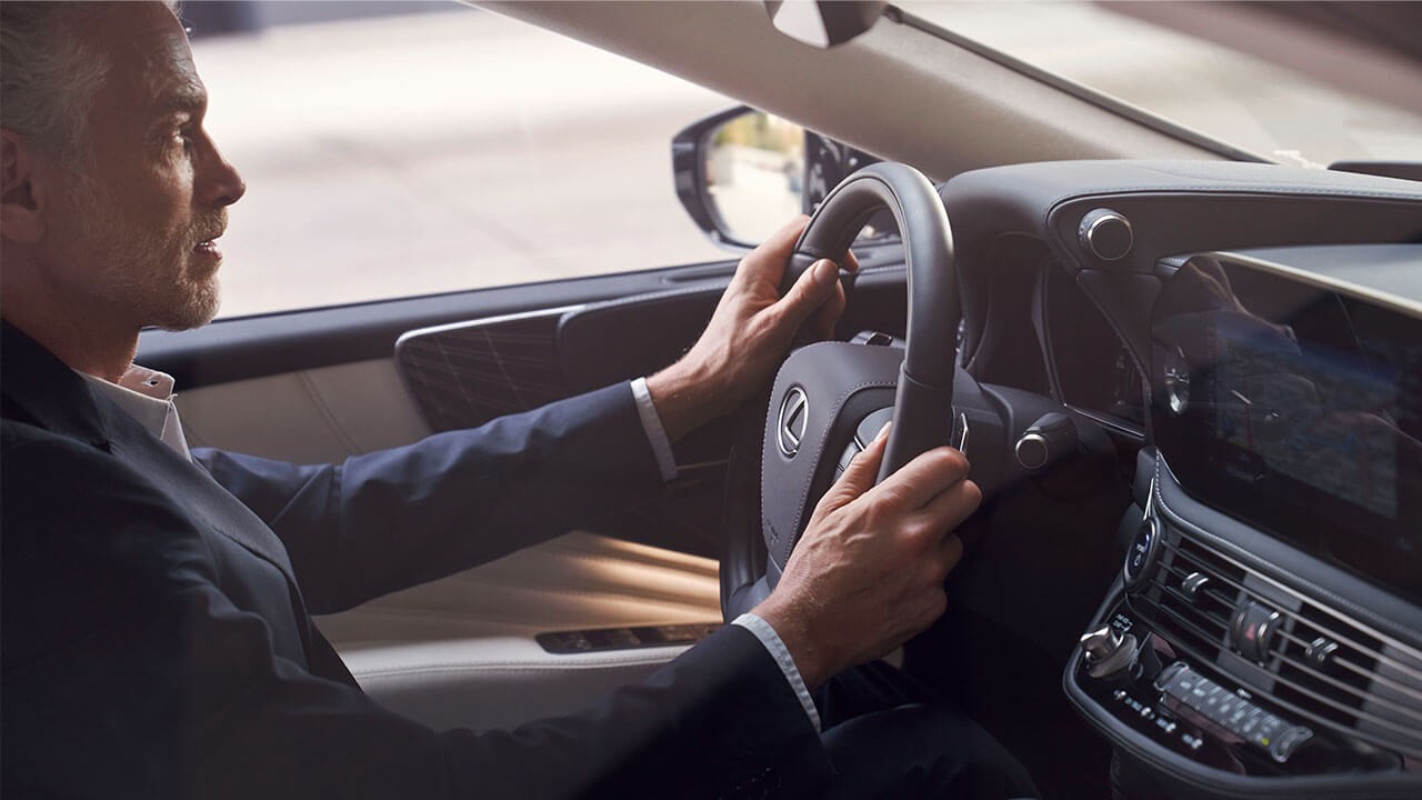 A man driving a Lexus LS