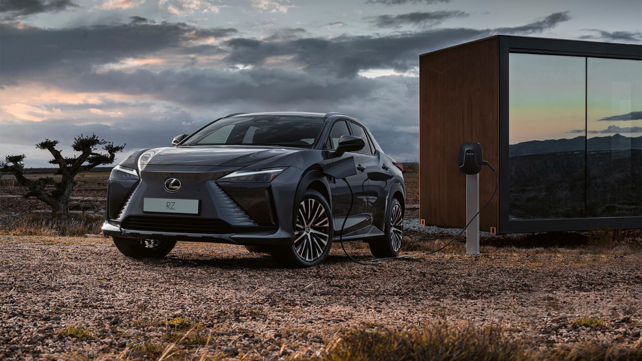 A Lexus RZ 450e plugged into a charging tower