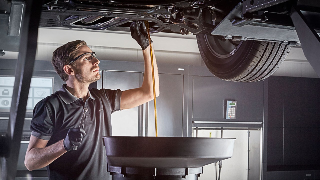 A Lexus mechanic changing a cars engine oil 